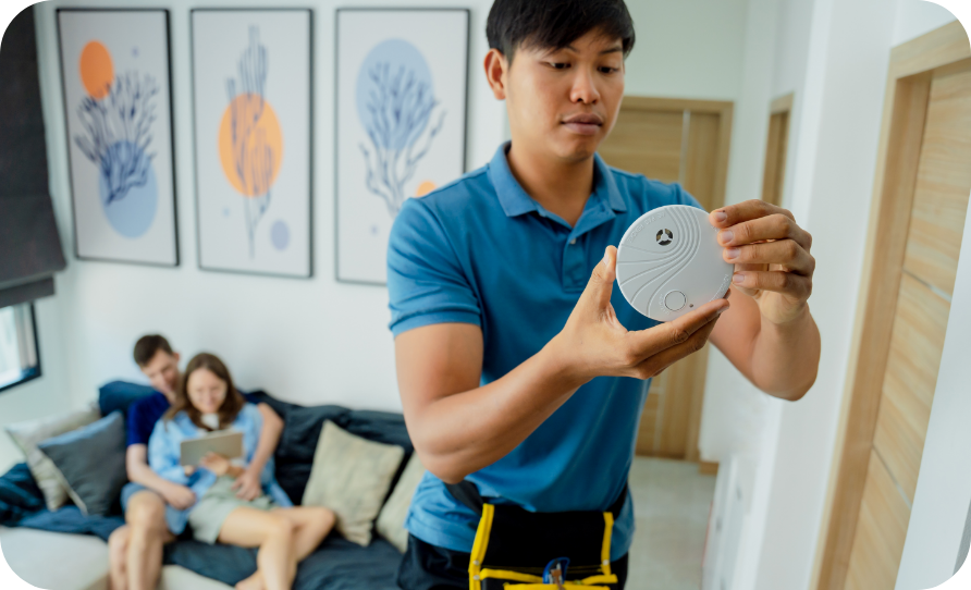 A man holding a carbon monoxide detector