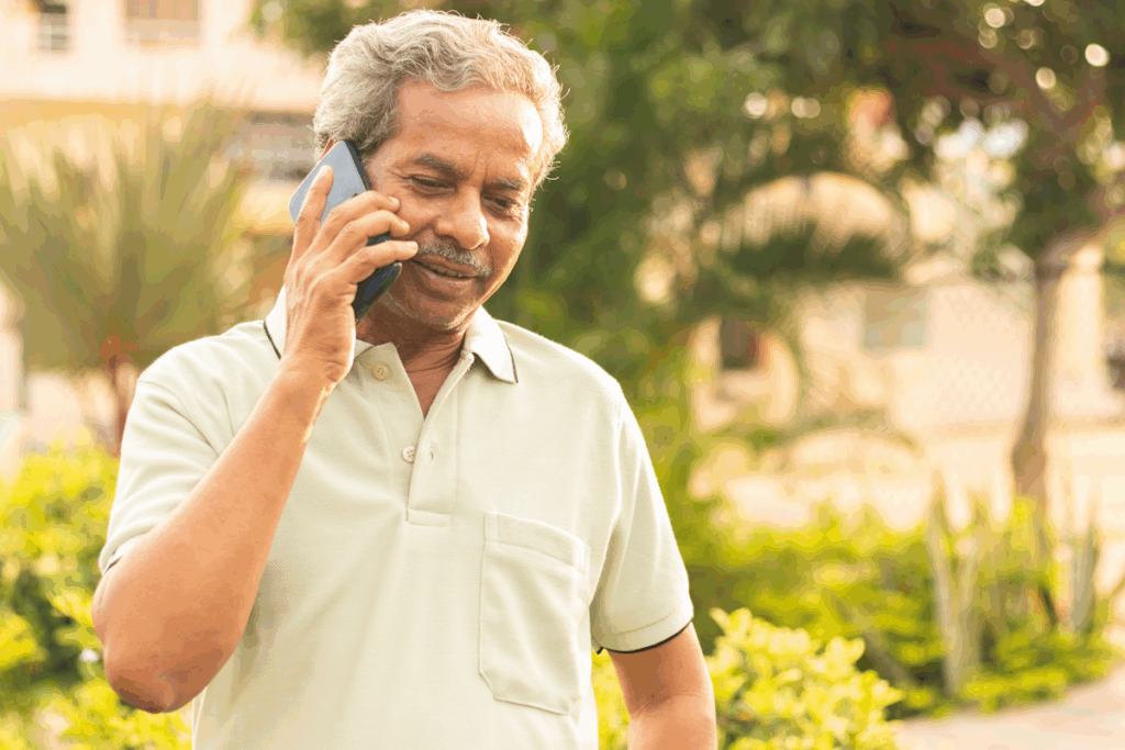 A man standing outside speaking on his smartphone.