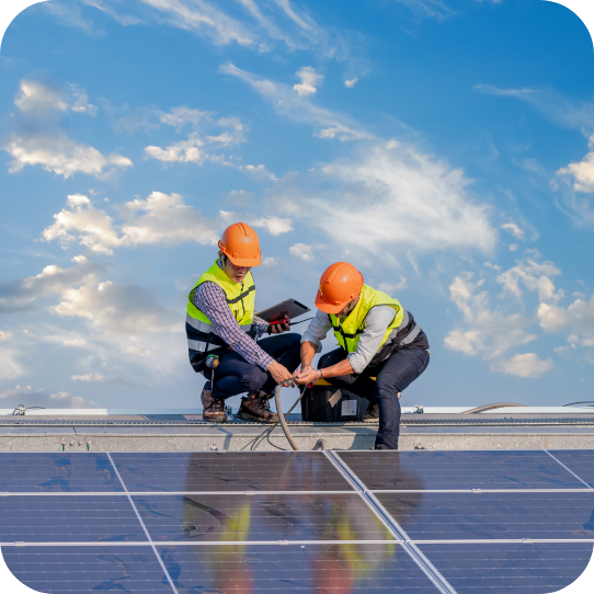 Two workers installing solar panels