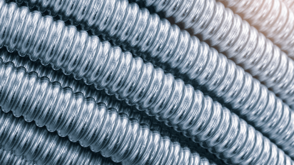 A closeup of coils of corrugated stainless steel tubing